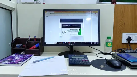 Office desk with a computer, calculator and stationery